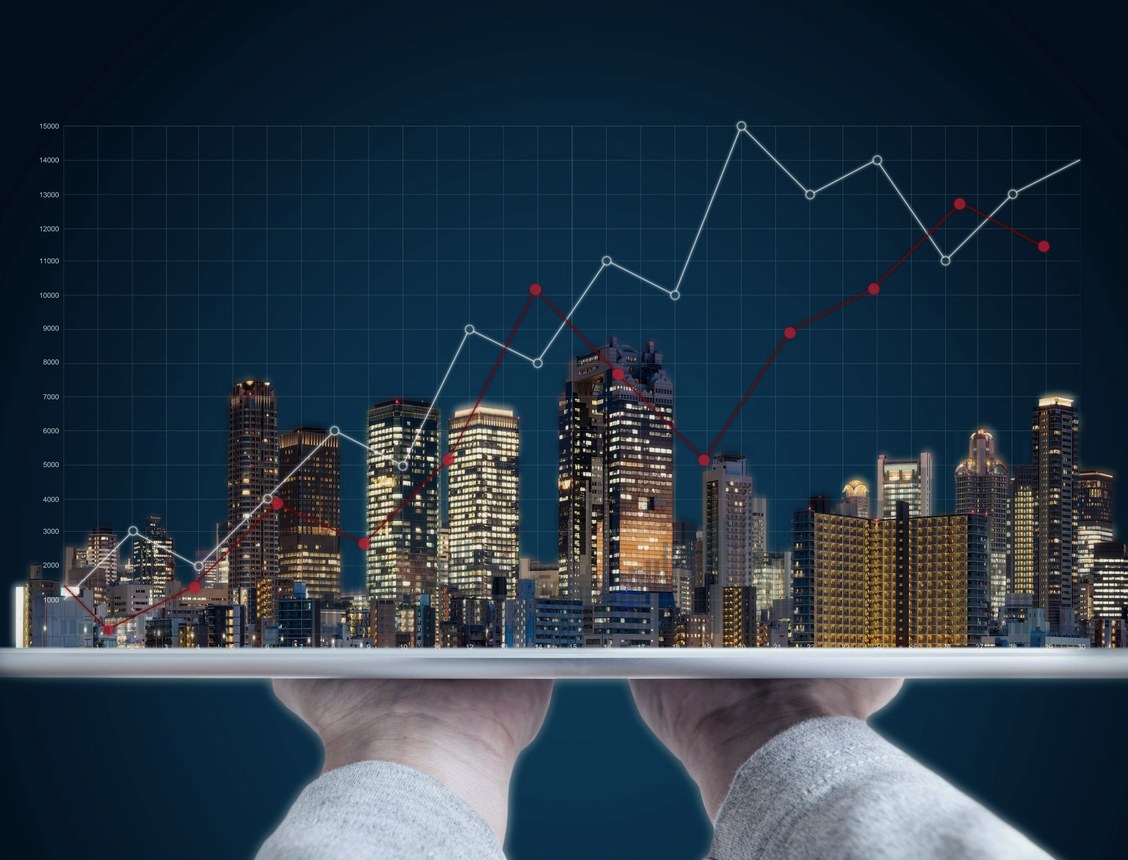 Market data displayed over a city skyline