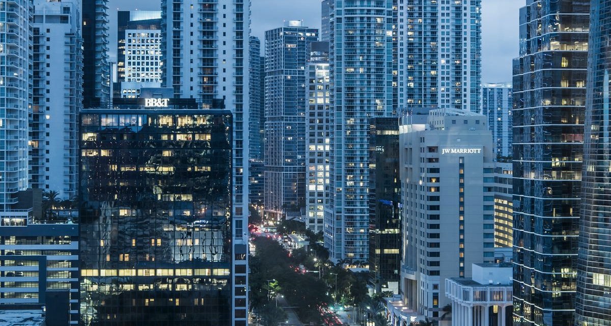 Lit apartment tower against a night skyline